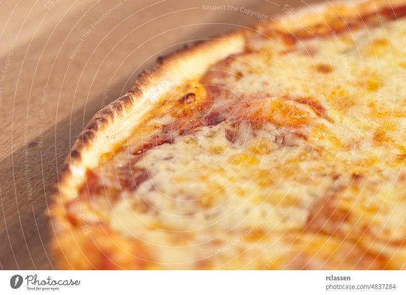 Close-up from a salami pizza jaws bread food Fast food cheese Delivery meal Pizza Pizzeria restaurant dough pizza dough catering wood tomato paste melting hot