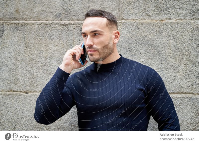 Man having phone call on smartphone man using communicate speak work male discuss remote busy job talk gadget device casual trendy listen building city handsome