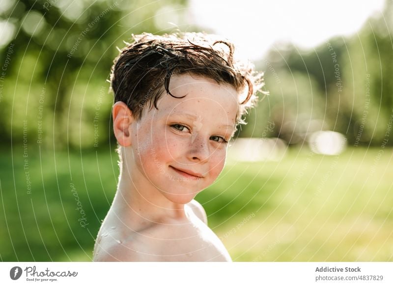 Portrait of boy at park portrait summer nature shirtless relax daytime smile sun happy charming sunlight vacation rest calm young countryside joy