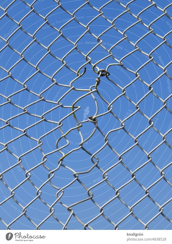 Mended wire mesh fence Wire netting fence Protection Safety Fence Barrier Border Wire fence Metal Exterior shot Deserted Captured Detail Sky Blue Silver Gray