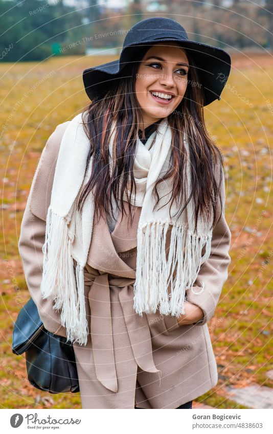 Young woman at autumn park adult outdoor female nature beautiful hat outside lady girl beauty cute fashion coat caucasian yellow forest person lifestyle young