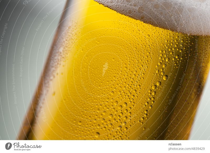 cold golden beer with condensation drops beer glass alcohol drunk refreshing restaurant yellow party drink summer bar brewery thirst disco barley malt oxygen