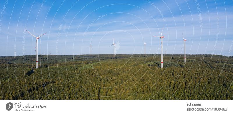 wind farm in the forest - energy production with clean and renewable energy - aerial shot turbine power environment fuel alternative drone electricity blue