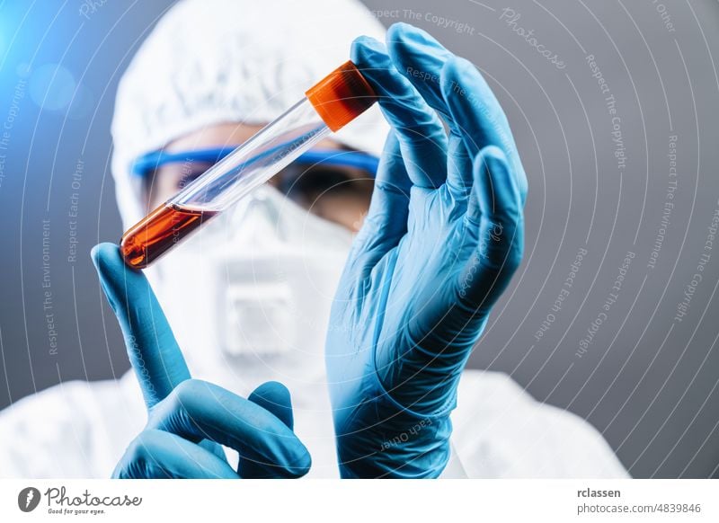 Female doctor or Scientist holds Invented red vaccine against covid 19 or Coronavirus corona coronavirus hospital ebola mask protection analyzing lab laboratory