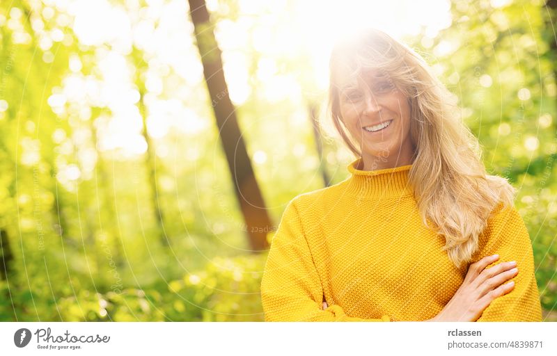 Close up portrait of beautiful woman with long blond on a sunny day in the Nature, with copy space for individual text adult attractive backlit blond hair