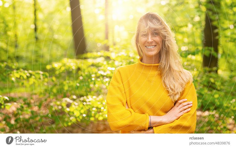 Close up portrait of beautiful woman with long blond on a sunny day in the Nature adult attractive backlit blond hair influencer brunette nature carefree