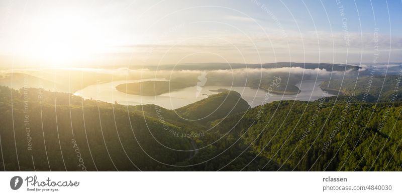 Lake Rursee in the Eifel National Park at the morning eifel rursee aerial blue drone green sunrise sunset national park nature outside panorama sun flare