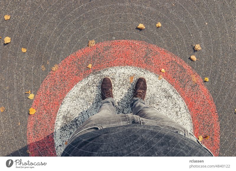 Young man stands in a circle at autumn on the streets, personal pespective from above. pov people lifestyle point view way caucasian young first person view