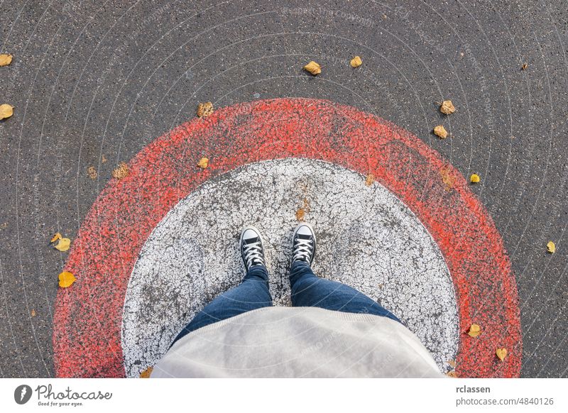 Young woman stands in a circle at autumn on the streets, personal pespective from above. pov people lifestyle point view way caucasian young first person view