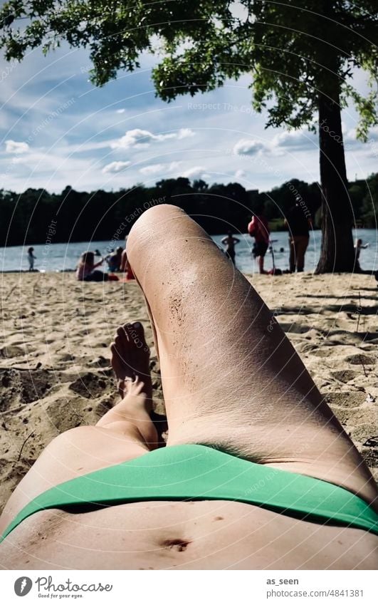 At the lake sunbathing sunbathe Bikini Lake Navel Irony wittily Summer vacation holidays idleness Lie leg Knee Stomach Green bikini pants Nature Pond