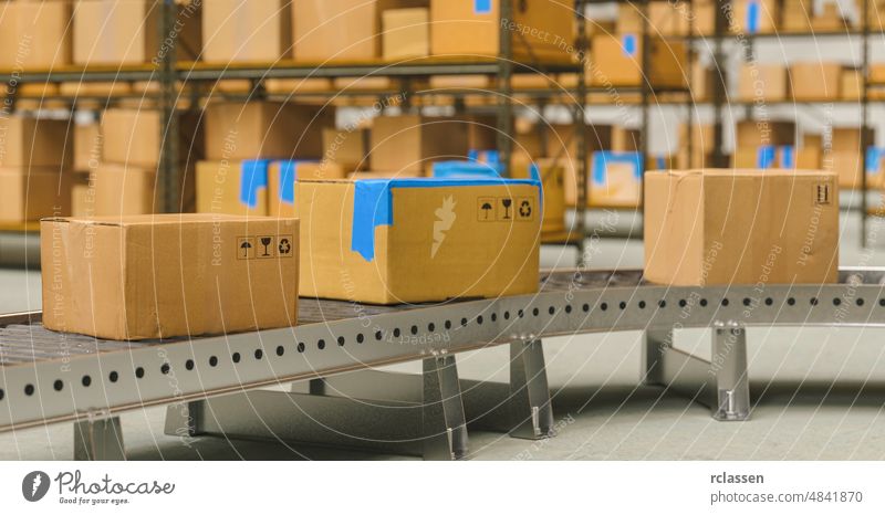 Packages delivery, packaging service and parcels transportation system concept, cardboard boxes on conveyor belt in warehouse package factory export product