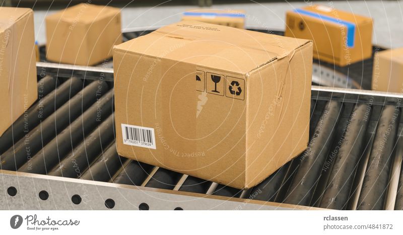 Box on conveyor roller. Warehouse or delivery concept image warehouse package box belt transport parcel sort product service distribution line purchase