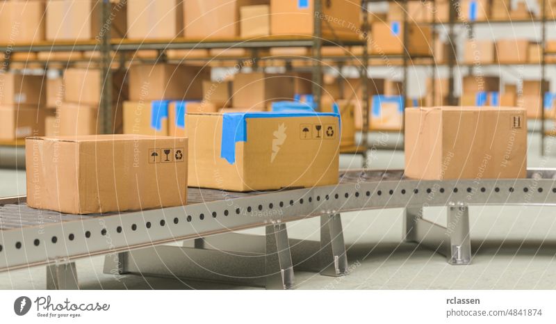 Packages delivery, packaging service and parcels transportation system concept, cardboard boxes on conveyor belt in warehouse package factory export product