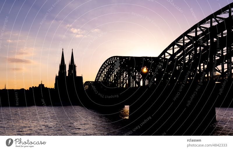 Cologne Cathedral and Hohenzollern Bridge silhouette city cathedral cologne sun oldtown sunset Rhine Germany river Carnival church bridge dusk gothik tourism