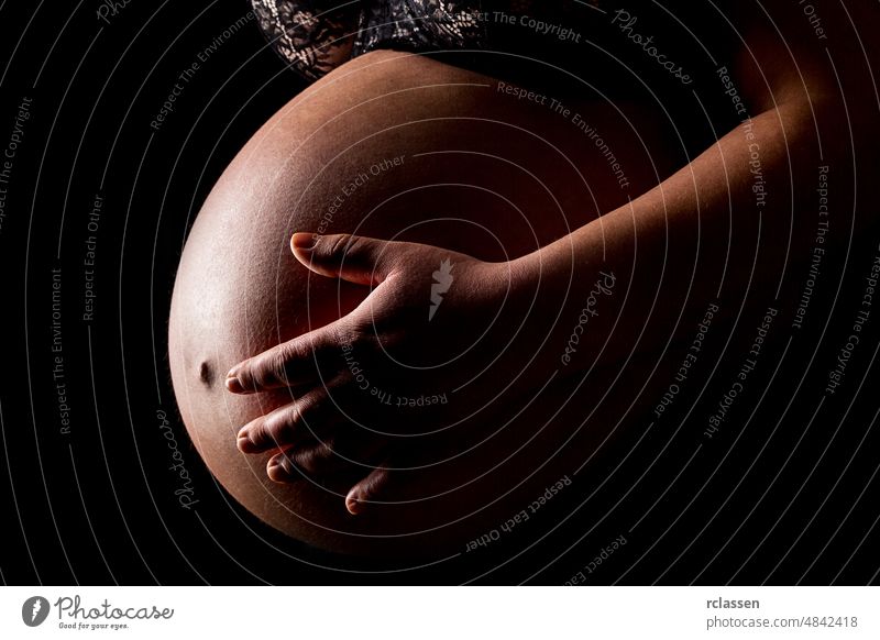 Pregnant woman caressing her belly baby pregnant navel pregnancy parents conception family ms fetus birth healthcare skin lovingly sex child maternity offspring