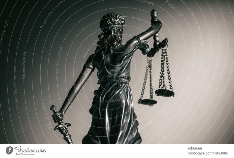 Statue of Justice from behind admonition attorney balance blind book bookshelf bronze business concept court court building courtroom crime debt female figure