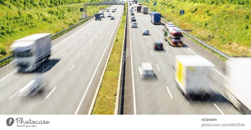 Highway traffic in germany transport highway truck car road vehicle street logistic lorry freight green urban summer cargo blue sky horizon nature driving