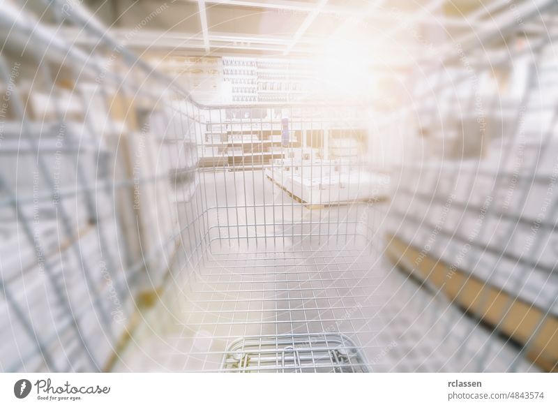Blurred  Supermarket with empty shopping cart supermarket trolley grocery isle retail aisle fast store defocused business basket wholesale purchase background