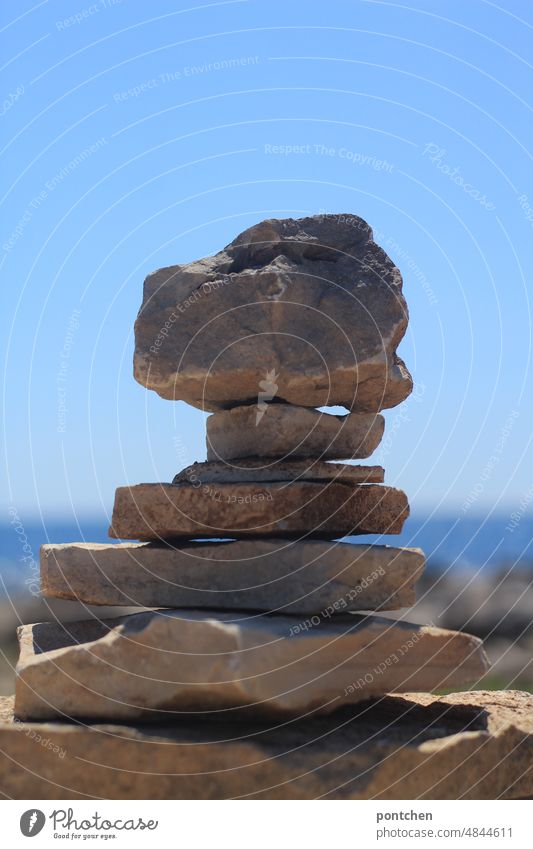 Stacked stones by the sea Stacking stones Ocean Hype Heavy Children's game Exterior shot Summer Sky Deserted