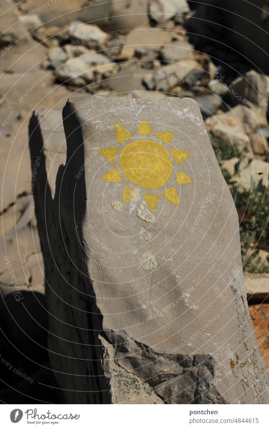 A sun painted on a rock. Summer, sun, vacation Sun symbol Rock Painting (action, artwork) Colour Yellow Vacation & Travel Shadow