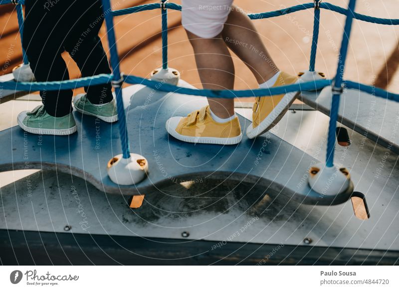 Close up children with canvas shoes playing on playground childhood Playground playground equipment Close-up colorful Exterior shot Playing Child Lifestyle Joy