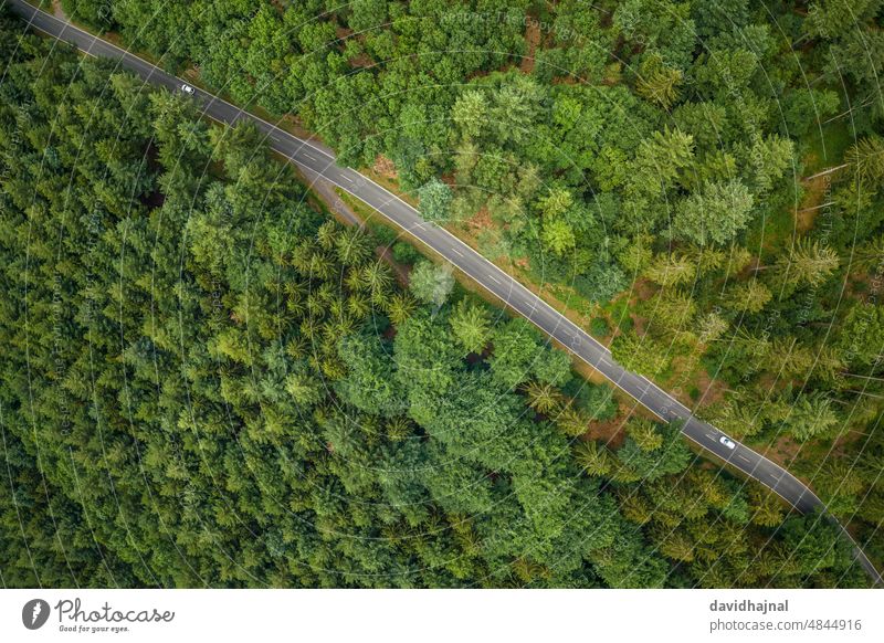 Aerial view of a road with two cars in the Odenwald landscape nature odenwald wilhelmsfeld europe germany rural tree green aerial aerial view forest drone