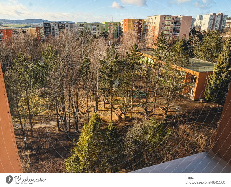 a view from a window on a playground and kindergarten with many trees and houses in the background Trees Nature Kindergarten children Window View from a window