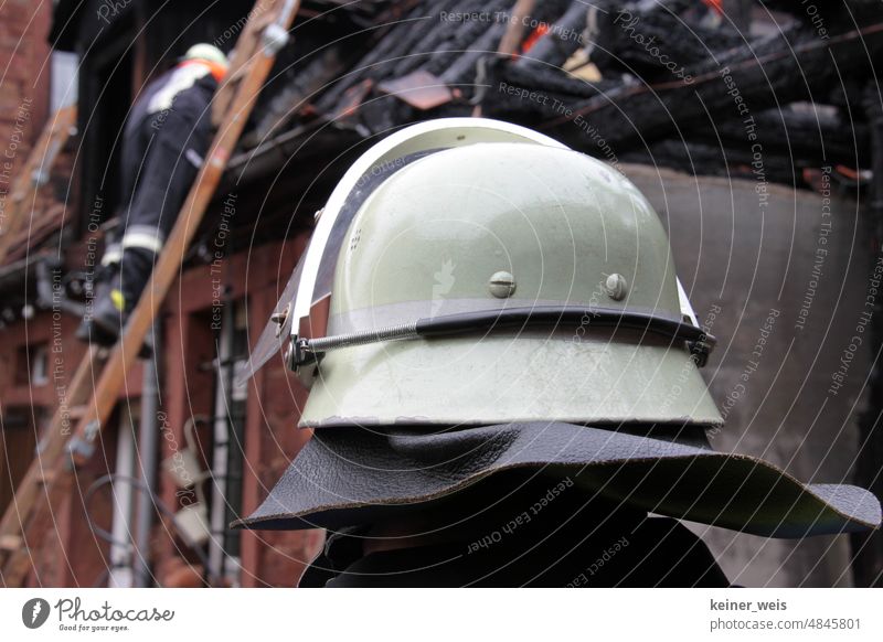 A firefighter anonymously under firefighter helmet in firefighting operation at a building fire Fireman Blaze fireman's helmet Building fire house fire