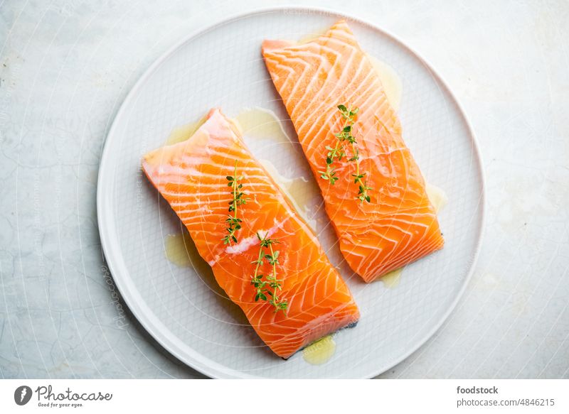 Fresh salmon fillet on a plate for delicious salmon steak. above background closeup cook cooking cuisine diet dinner eating fat fish food fresh freshness