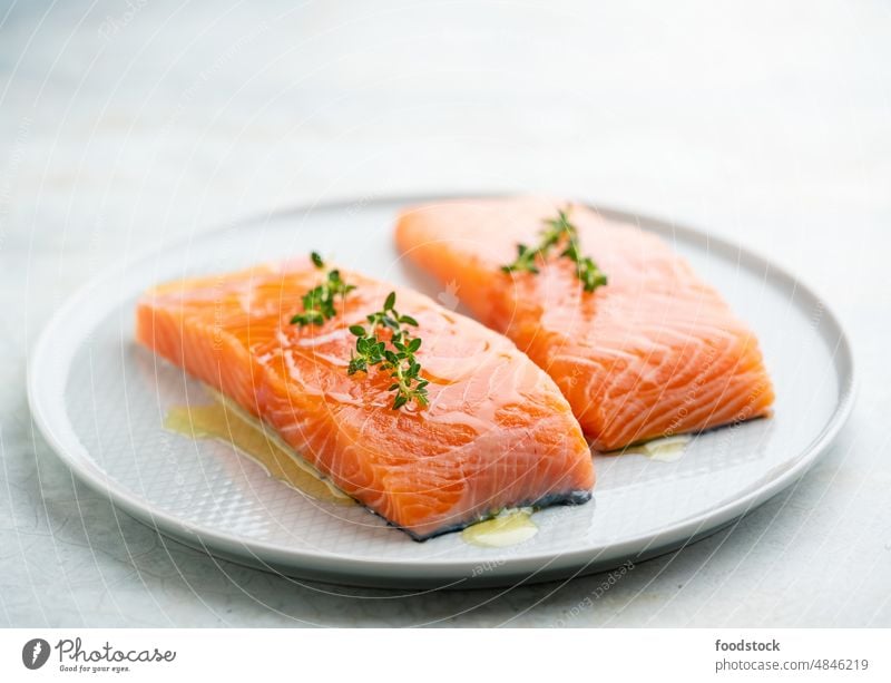 Fresh salmon fillet on a plate for delicious salmon steak. above background closeup cook cooking cuisine diet dinner eating fat fish food fresh freshness