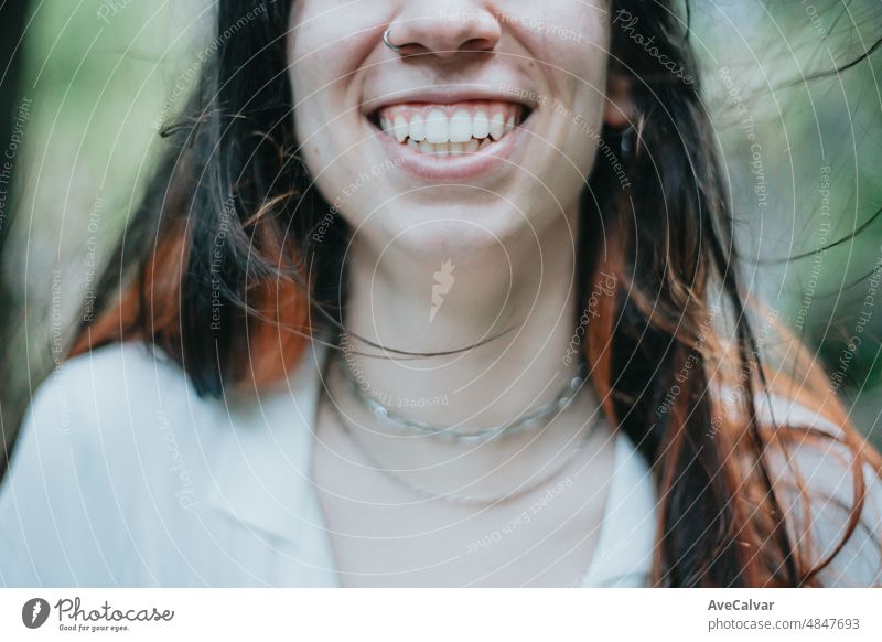Close up image of a young woman smile with big teeth and cute dimples. Therapy and looking for help,psychology and psychiatry concepts,copy space women hands