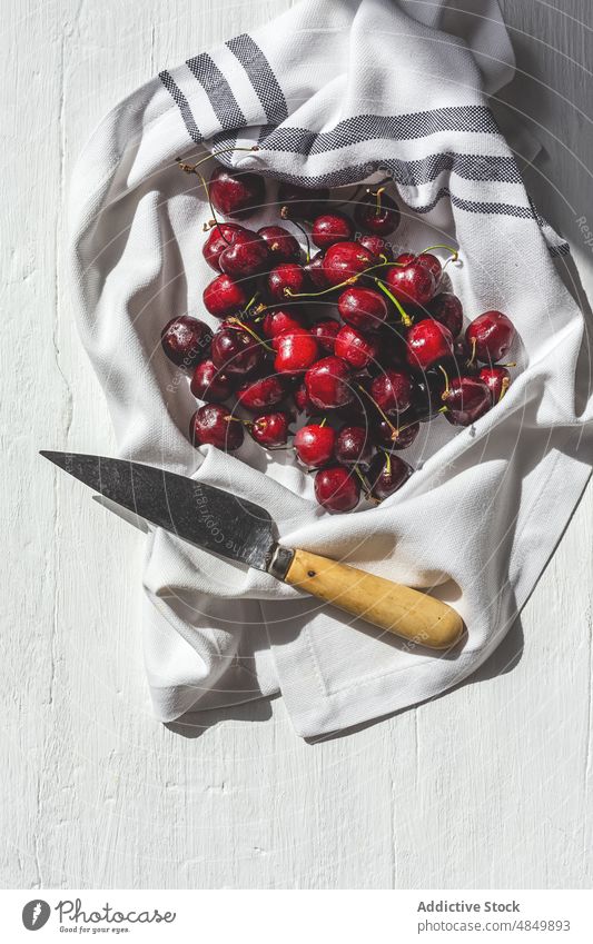 Cherry's placed on kitchen cloth on white background cherry fruit fresh food berry organic ripe red table natural delicious knife tasty healthy sweet juice