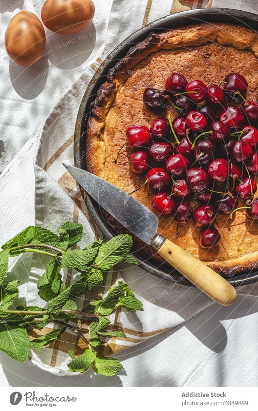 Freshly baked cherry pie on table cake crust rustic served green gourmet culinary wood whole recipe round fresh berry sweet traditional cream mint pastry shells