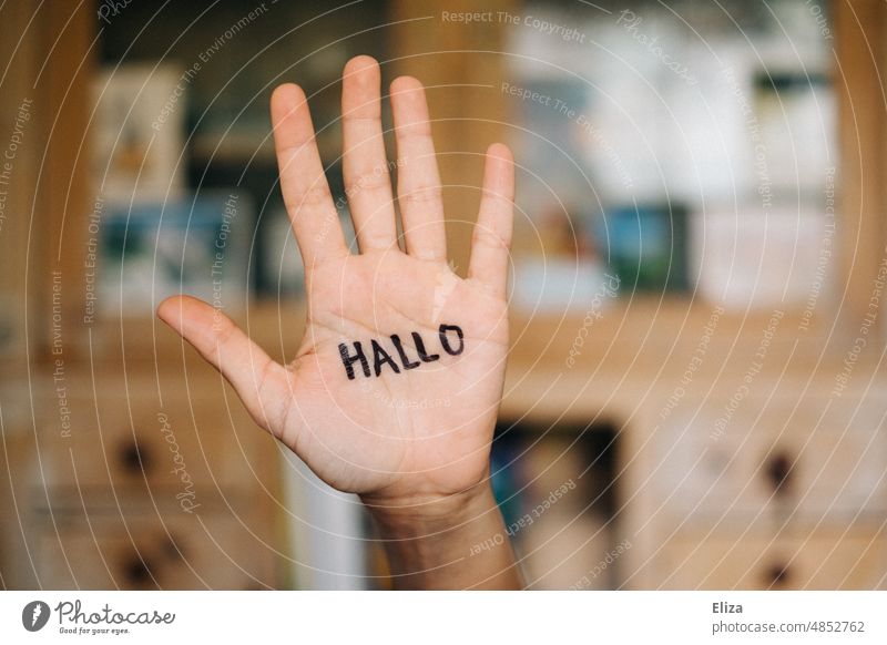 Hand on which is written hello Hello Welcome authored Communicate Salutation Human being Text salute sb. Characters