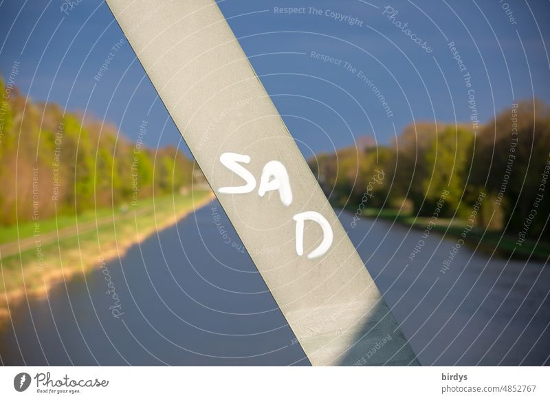 sad, sad, writing on a bridge strut. In the blurred background a river Sadness Characters Bridge River Emotions Distress depression dejected Grief Loneliness