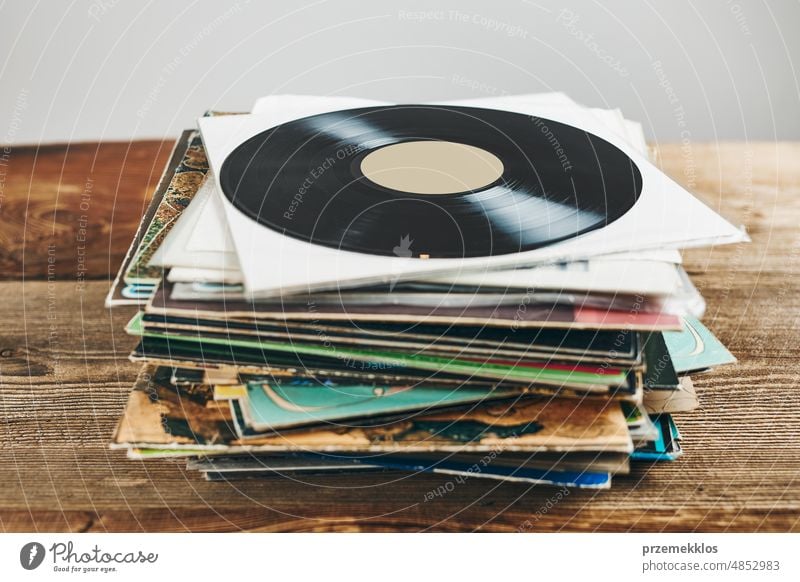 Stack of vinyl records. Listening to music from record. Playing music from analog disk. Retro and vintage. Audio stereo. Analog sound listening album retro