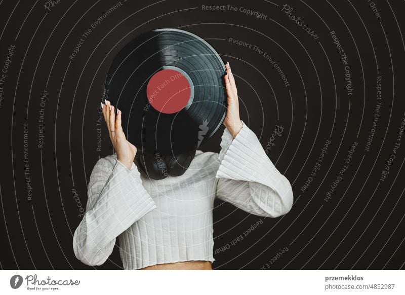 Woman holding vinyl record. Music passion. Listening to music from analog record. Playing music from analog disk. Enjoying music from old collection. Retro and vintage. Stereo audio. Analog sound