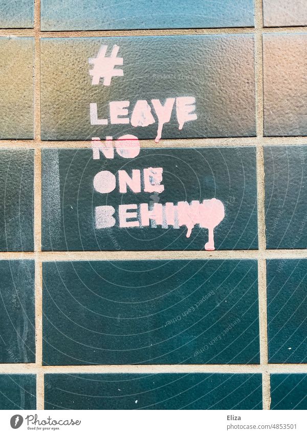 Leave no one behind graffiti on a house wall leave no one behind Fugitives Graffiti Pink sprayed Typography sea rescue Solidarity Help writing politically