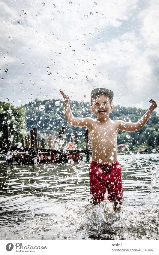 Child standing in water and splashing with water Water Drops of water Playing cooling Inject Summer Refreshment Swimming & Bathing Vacation & Travel