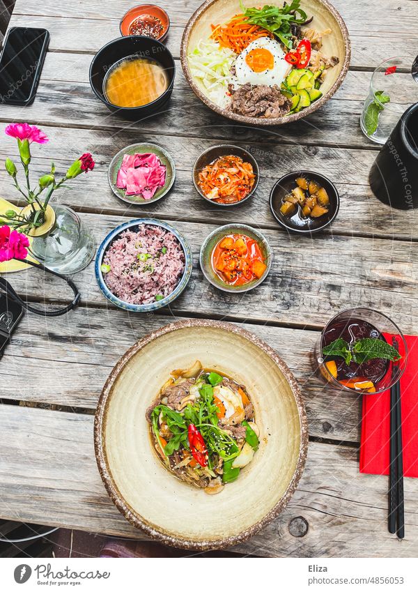 Bibimbap and Bulgogi - Colorful Korean Food on a Table Eating Residual restaurant Asian Meal Delicious variegated chopsticks bowls Plate bulgogi colourful