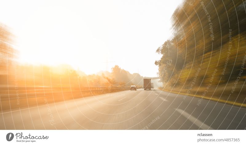 Highway motion view in early autumn foggy, copyspace for your individual text. motorway car road engine rush hour asphalt autumn forest logistic motion blur