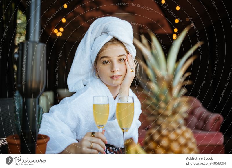 Woman in towels drinking cocktail on terrace woman morning patio hobby leisure juice beverage feminine summer glass table female style summertime thoughtful