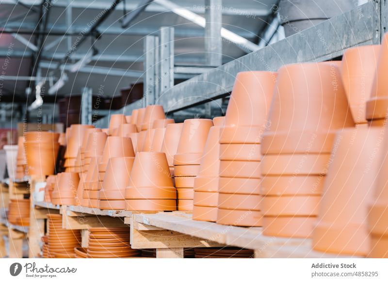 Stacks of pots on shelves shelf shop warehouse stack commerce many storage collection market industry storehouse ceramic pile row fragile daytime trade sell
