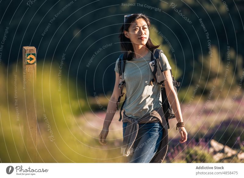 Traveling Asian woman with backpack walking in nature travel hiker trekking adventure tourism explore journey valverde de los arroyos guadalajara