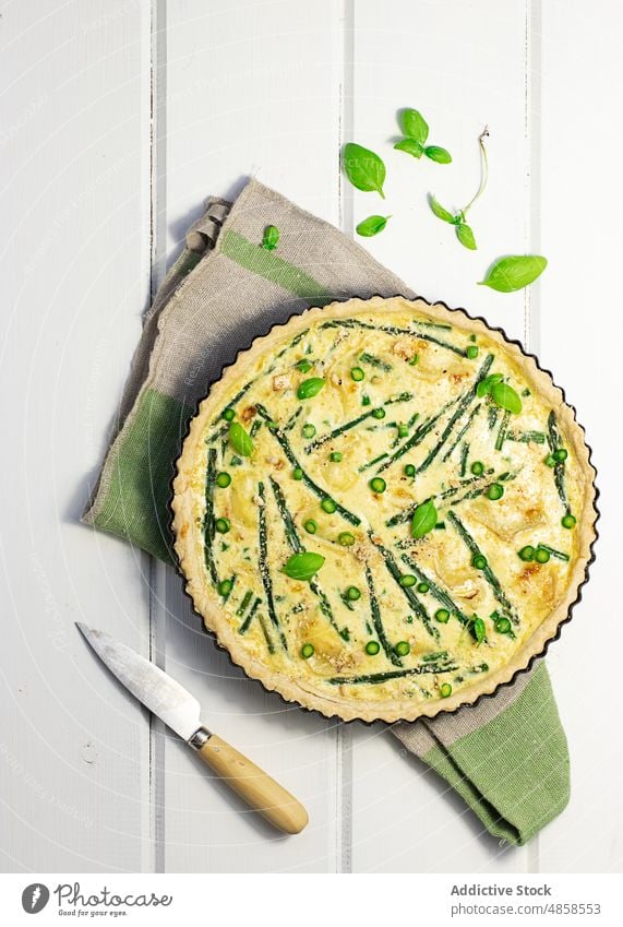 A quiche with basil leaves placed on wooden table cream savory tasty baking bake french food healthy spring top view leaf baked asparagus gastronomy cheese dish