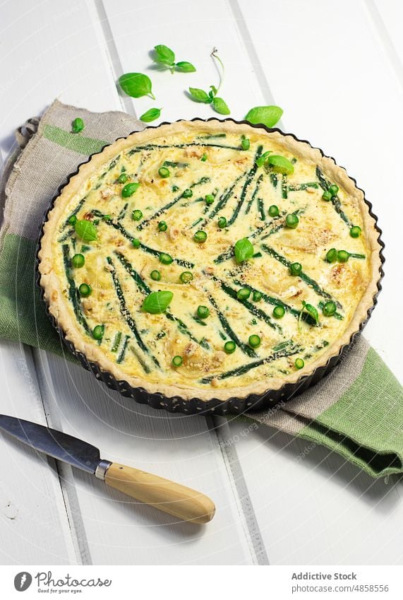 A quiche with basil leaves placed on wooden table cream savory tasty baking bake french food healthy spring top view leaf baked asparagus gastronomy cheese dish