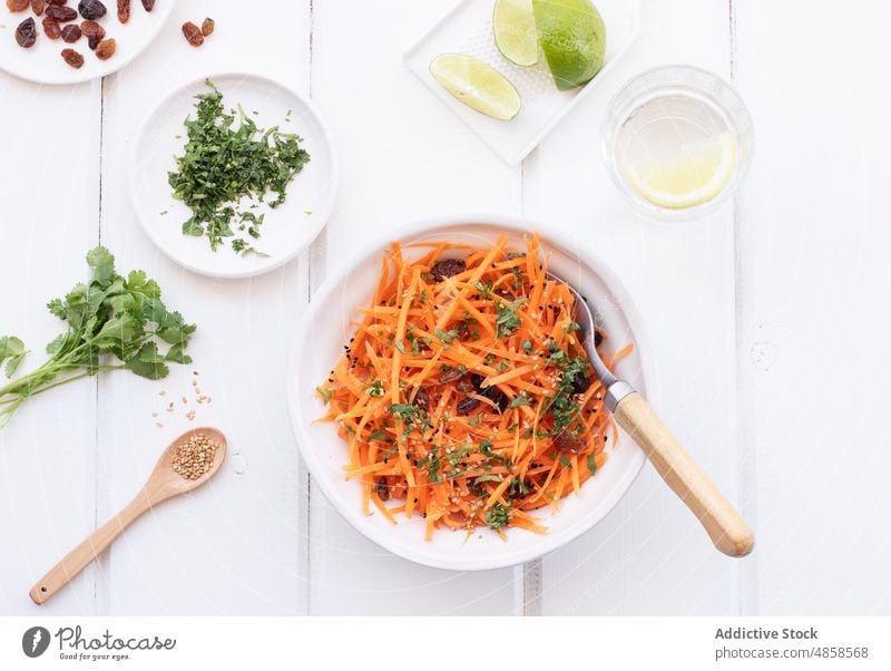 Grated carrot salad on wooden table vegetarian food homemade lime coriander parsley leaf raw vegetables carrots snack nobody lunch grated dressing leaves