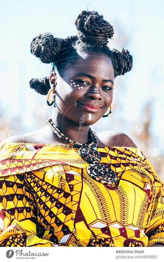 African woman in bright traditional dress style field outfit makeup portrait print appearance personality sunlight female black african ethnic ornament dry