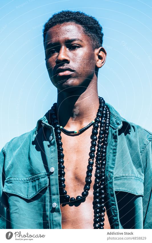 African man in denim clothes in countryside style fashion outfit tradition summer grass model casual accessory african ethnic black blue sky cloudless sky
