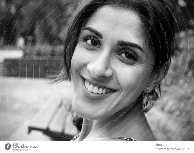 smiling woman in park portrait feminine Smiling cheerful contented fortunate Park Dark-haired Long-haired Jewellery Looking Trust Park bench Feminine